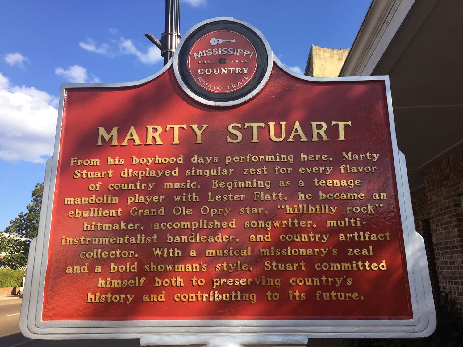 A closeup of Philadelphia, Mississippi Music Country Trail sign of Marty Stuart's life